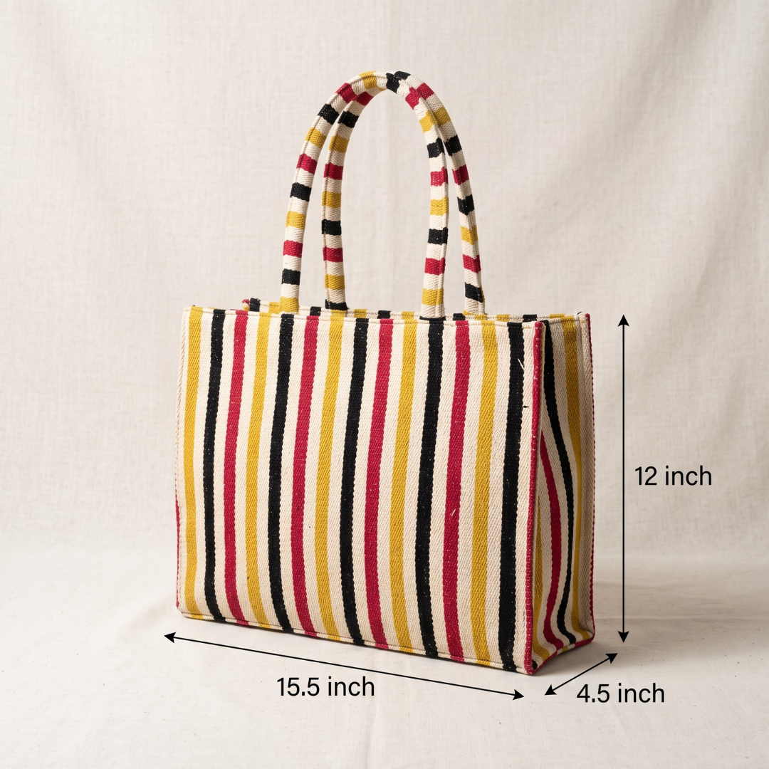A striped tote bag with yellow, black, red, and white vertical stripes, shown with dimension lines indicating its measurements: 15.5 inch width, 12 inch height, and 4.